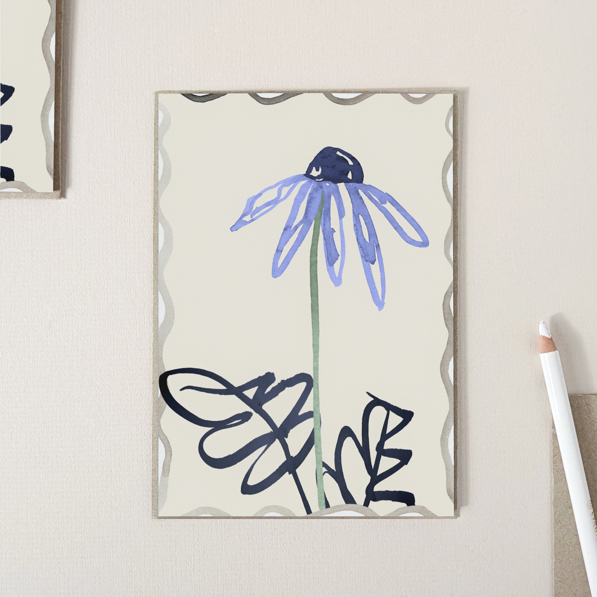 A  greeting card featuring a hand drawn blue flower with dark navy leaves on a warm cream background.