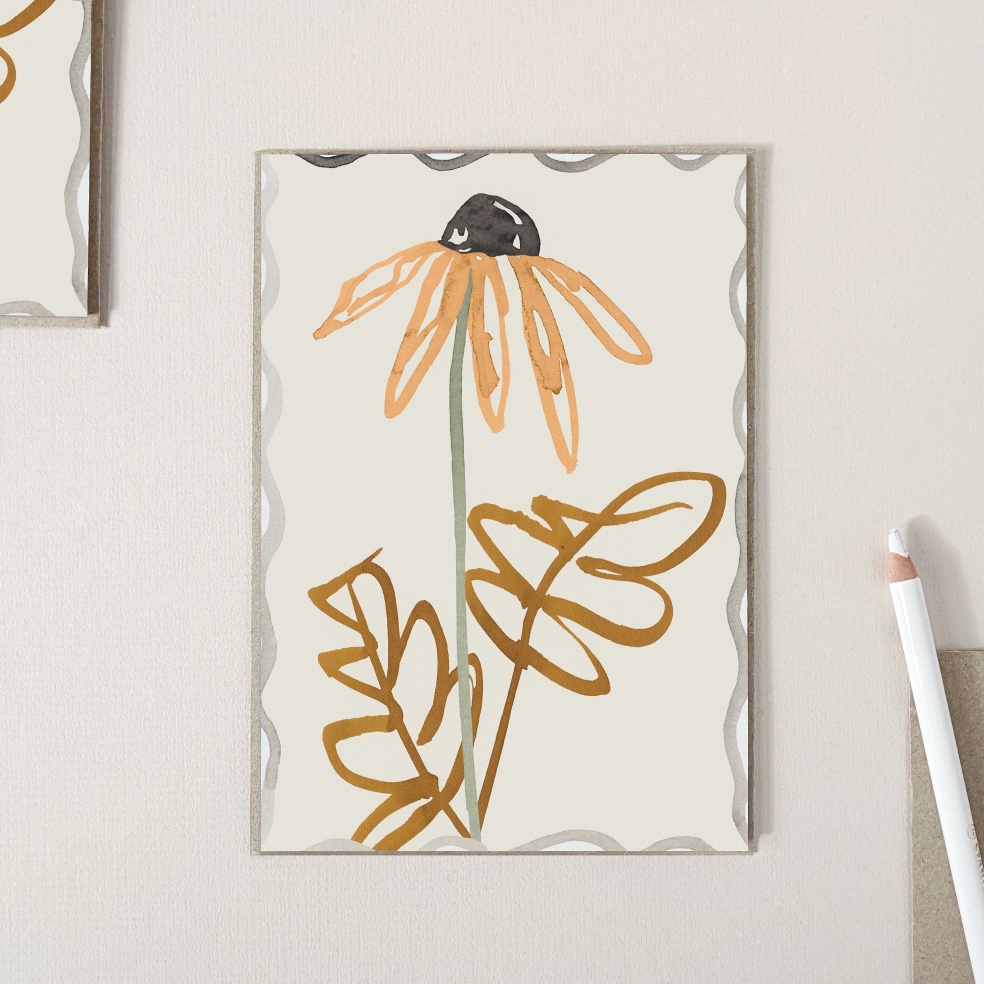 A greeting card featuring a large hand drawn orange daisy with brown leaves on a warm cream background.