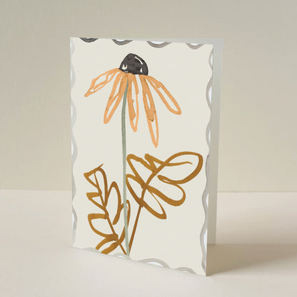 A greeting card with a scalloped border, featuring a minimalist illustration of a orange daisy on a warm cream background.